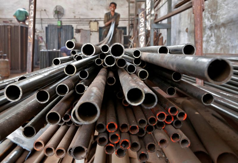 &copy; Reuters. FILE PHOTO: A worker stacks steel pipes in the western Indian city of Ahmedabad November 4, 2014.  REUTERS/Amit Dave/File Photo