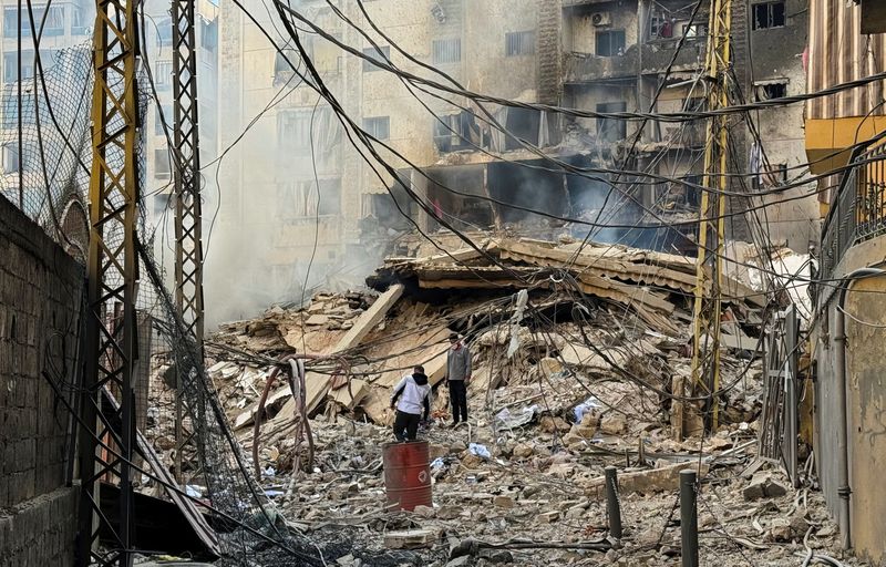 © Reuters. Men walk on the rubble at a site damaged in the aftermath of Israeli strikes on Beirut's southern suburbs, amid the ongoing hostilities between Hezbollah and Israeli forces, Lebanon, October 24, 2024. REUTERS/Ahmad Al-Kerdi