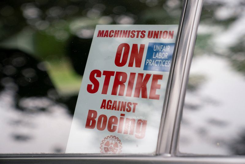 &copy; Reuters. A strike sign is seen in a Boeing worker's car as union members from the International Association of Machinists and Aerospace Workers District 751 arrive to vote on a new contract proposal at a union hall during an ongoing strike in Renton, Washington, U