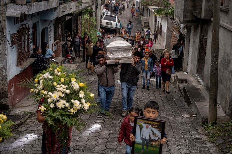 &copy; Reuters. Family members carry the body of Widman Alexander Tax Chinic, 26, who drowned four months earlier trying to cross into the U.S., from the family's home to their church in Yepocapa, Guatemala, June 19, 2024. Widman and his partner Rossanna Azucena Coche Na