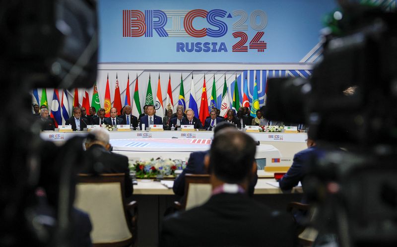 &copy; Reuters. Officials, including Russian President Vladimir Putin, Chinese President Xi Jinping and Egyptian President Abdel Fattah al-Sisi, are seen through television cameras during a plenary session in the outreach/BRICS Plus format at the BRICS summit in Kazan, R