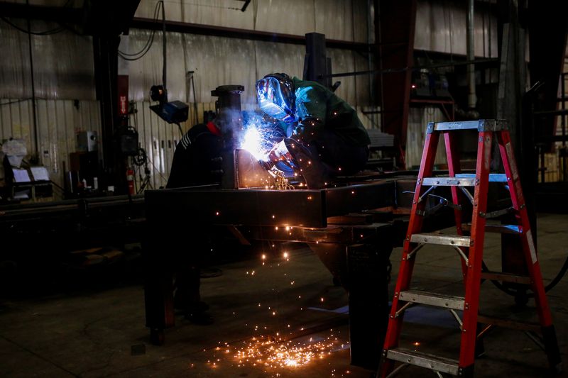 &copy; Reuters. FILE PHOTO: Matt Dillion and Chad Damron weld an upper deck assembly at Look Trailers cargo trailer manufacturing facility in Middlebury, Indiana, U.S., April 1, 2021. REUTERS/Eileen T. Meslar/File Photo