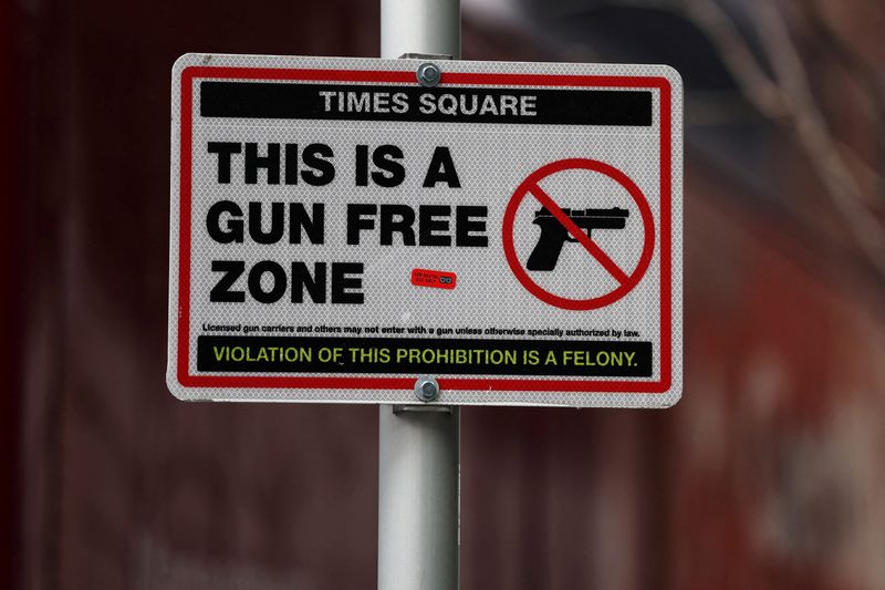 &copy; Reuters. FILE PHOTO: A sign informs about the "Gun Free Zone" in the Times Square area of New York City, U.S., March 15, 2024. REUTERS/Shannon Stapleton/File Photo