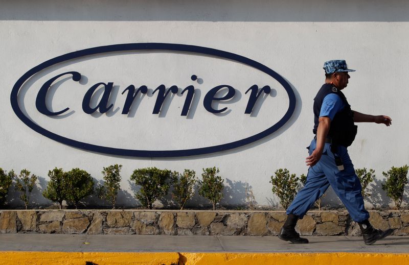 © Reuters. FILE PHOTO: A private security guard walks past a logo of Carrier Corp outside the air conditioner plant, a unit of United Technologies Corp, in Santa Catarina, on the outskirts of Monterrey, Mexico, February 17, 2016. REUTERS/Daniel Becerril/File Photo