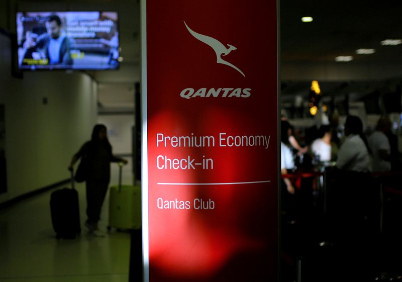 &copy; Reuters. A passenger walks with their luggage as they approach a Qantas Airways check-in counter at Sydney International Airport in Australia, October 25, 2017. REUTERS/Steven Saphore/ File Photo