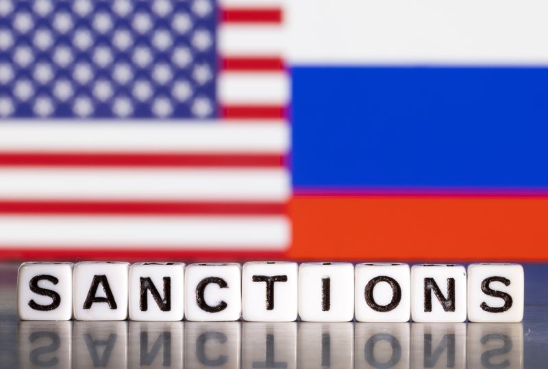 &copy; Reuters. Plastic letters arranged to read "Sanctions" are placed in front the flag colors of U.S. and Russia in this illustration taken February 28, 2022. REUTERS/Dado Ruvic/Illustration