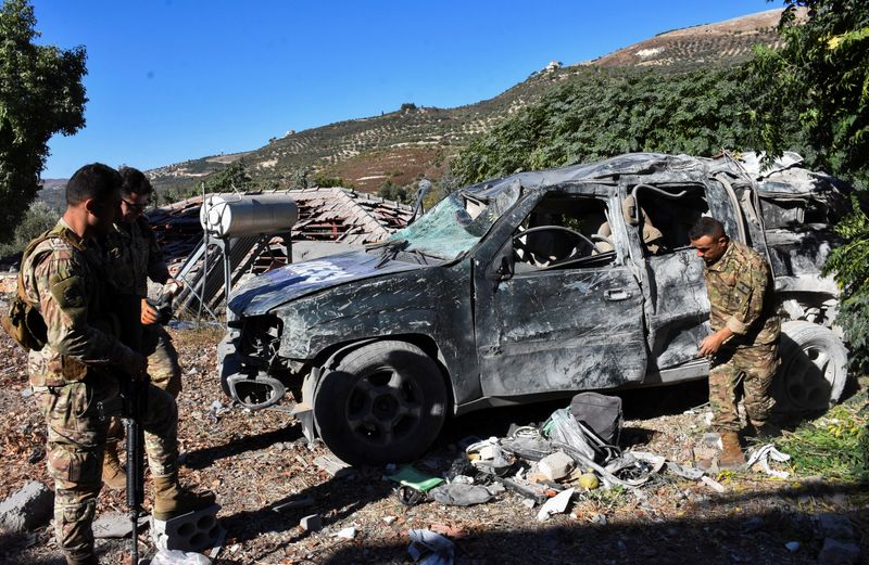 &copy; Reuters. Lebanese army soldiers inspect a damaged vehicle marked with 'Press' at the site of an Israeli strike that killed a few journalists and wounded several others as they slept in guesthouses used by media, Lebanon's health ministry and local media reported, 