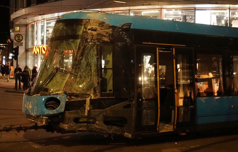 © Reuters. People stand near a tram after it was pulled out of a shop it crashed into, in Oslo, Norway October 29, 2024.      REUTERS/Tom Little