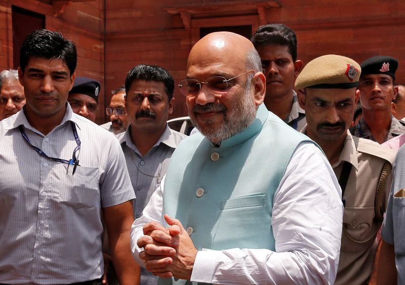 © Reuters. FILE PHOTO: India's newly appointed Home Minister Amit Shah greets the media upon his arrival at the home ministry in New Delhi, India, June 1, 2019. REUTERS/Altaf Hussain/File Photo