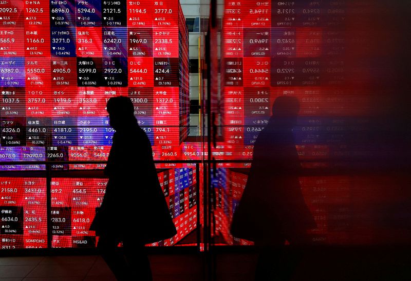 &copy; Reuters. FILE PHOTO: A visitor walks past Japan's Nikkei stock prices quotation board inside a building in Tokyo, Japan February 19, 2024. REUTERS/Issei Kato/File Photo