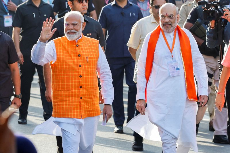 © Reuters. FILE PHOTO: India's Prime Minister Narendra Modi (L) walks alongside Amit Shah, Indian Home Minister and leader of India's ruling Bharatiya Janata Party (BJP) on the day he casts his vote, outside a polling station during the third phase of the general election, in Ahmedabad, India, May 7, 2024. REUTERS/Adnan Abidi/File Photo