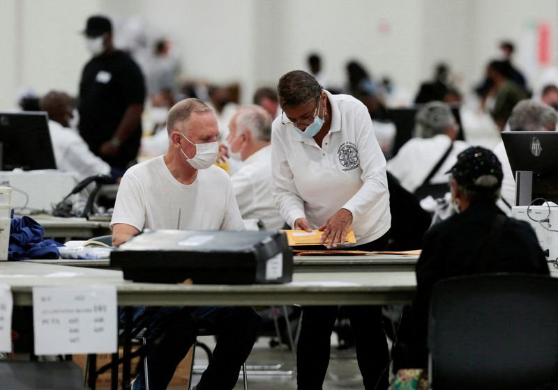 &copy; Reuters. FILE PHOTO: Election workers prepare absentee ballots for counting at Huntington Place during the primary election in Detroit, Michigan, U.S. August 2, 2022.  REUTERS/Rebecca Cook/File Photo