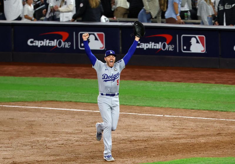 &copy; Reuters. Oct 30, 2024; Bronx, New York, USA; Los Angeles Dodgers first baseman Freddie Freeman celebrates after the final out against the New York Yankees during game five of the 2024 MLB World Series at Yankee Stadium. Mandatory Credit: James Lang-Imagn Images