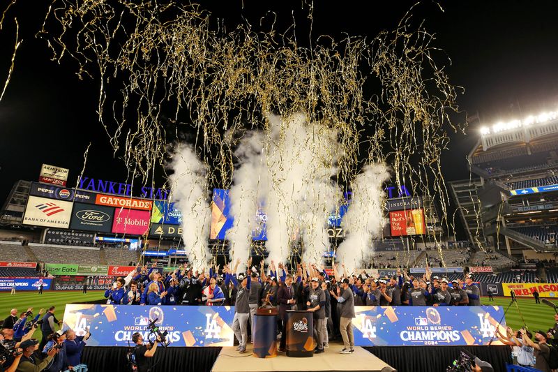 © Reuters. Oct 31, 2024; New York, New York, USA; The Los Angeles Dodgers celebrates with the Commissioner’s Trophy after beating the New York Yankees in game four to win the 2024 MLB World Series at Yankee Stadium. Mandatory Credit: Brad Penner-Imagn Images