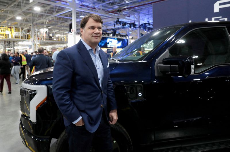 &copy; Reuters. FILE PHOTO: Ford CEO Jim Farley poses next to a model of the all-new Ford F-150 Lightning electric pickup truck at the Ford Rouge Electric Vehicle Center in Dearborn, Michigan, U.S. April 26, 2022. REUTERS/Rebecca Cook/File Photo