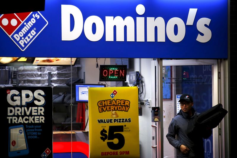 &copy; Reuters. A worker carries a pizza for delivery as he exits a Domino's pizza store in Sydney, Australia, August 12, 2015. REUTERS/David Gray/File Photo