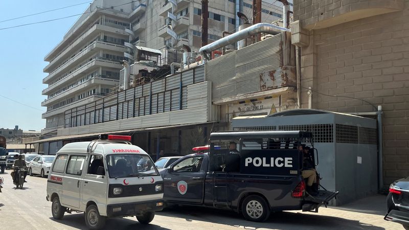 © Reuters. A view of police mobile and an ambulance outside a factory where according to police, two Chinese nationals were shot at and injured, in Karachi, Pakistan November 5, 2024. REUTERS/Akhtar Soomro