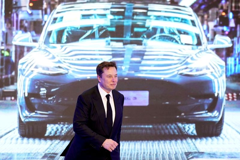 &copy; Reuters. FILE PHOTO: Tesla Inc CEO Elon Musk walks next to a screen showing an image of Tesla Model 3 car during an opening ceremony for Tesla China-made Model Y program in Shanghai, China January 7, 2020. REUTERS/Aly Song//File Photo