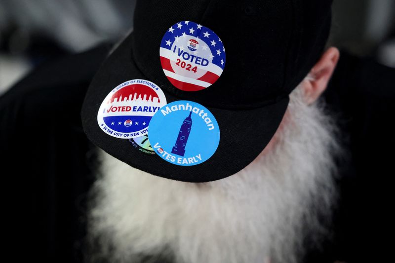 © Reuters. A man wears an hat with stickers, on Election Day for the 2024 U.S. presidential election in Manhattan, New York City, U.S., November 5, 2024. REUTERS/Andrew Kelly