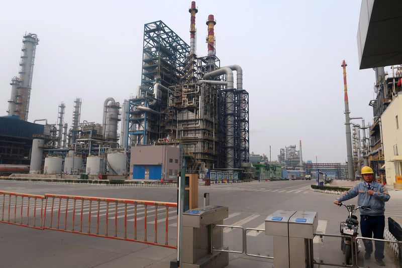 © Reuters. FILE PHOTO: A man is seen at an exit of the refinery plants of Chambroad Petrochemicals in Binzhou, Shandong province, China October 24, 2019. REUTERS/Stringer/File Photo