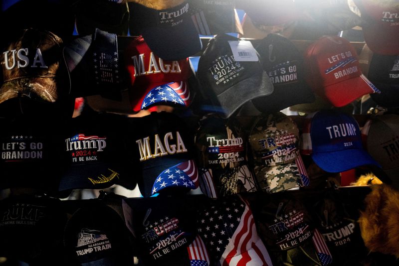 © Reuters. FILE PHOTO: Merchandise for sale are displayed outside the venue where Republican presidential nominee and former U.S. President Donald Trump is expected to hold a campaign rally in Grand Rapids, Michigan, U.S., November 4, 2024. REUTERS/Emily Elconin/File Photo