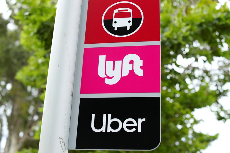 © Reuters. FILE PHOTO: A sign marks a rendezvous location for Lyft and Uber users at San Diego State University in San Diego, California, U.S., May 13, 2020.      REUTERS/Mike Blake/File Photo