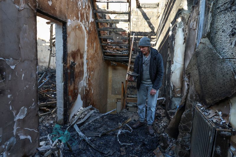 © Reuters. A resident stands inside of his house destroyed by a Russian drone strike, amid Russia's attack on Ukraine, in Odesa, Ukraine November 8, 2024. REUTERS/Nina Liashonok/File Photo