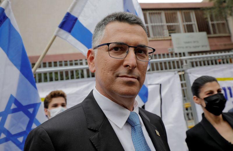 &copy; Reuters. FILE PHOTO: Leader of the New Hope party Gideon Saar and his wife Geula walk outside a polling station during a general election in Tel Aviv, Israel March 23, 2021.  Jalaa Marey/Pool via REUTERS/File Photo