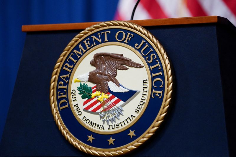 © Reuters. FILE PHOTO: The seal of the U.S. Justice Department is seen on the podium in the Department's headquarters briefing room before a news conference with the Attorney General in Washington, January 24, 2023. REUTERS/Kevin Lamarque/File Photo