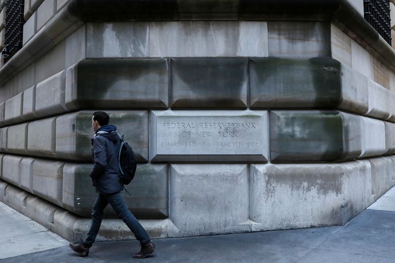 © Reuters. FILE PHOTO: A man passes by the corner stone on the Federal Reserve Bank of New York in the financial district in New York City, U.S., March 4, 2019. REUTERS/Brendan McDermid/File Photo