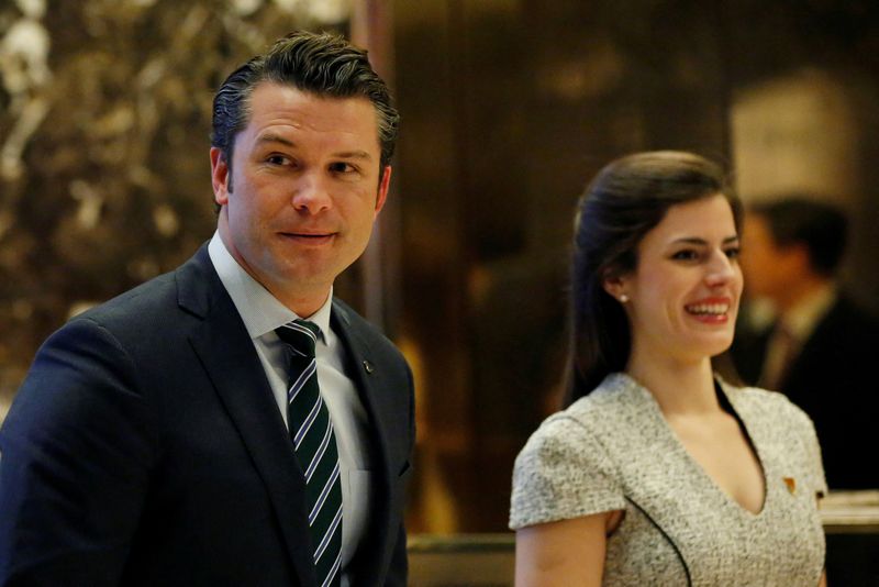 © Reuters. FILE PHOTO: Pete Hegseth, former executive director of Vets For Freedom, looks at the media members while waiting for the escalator in the lobby of Trump Tower in Manhattan, New York, U.S., December 15, 2016. REUTERS/Shannon Stapleton/File Photo