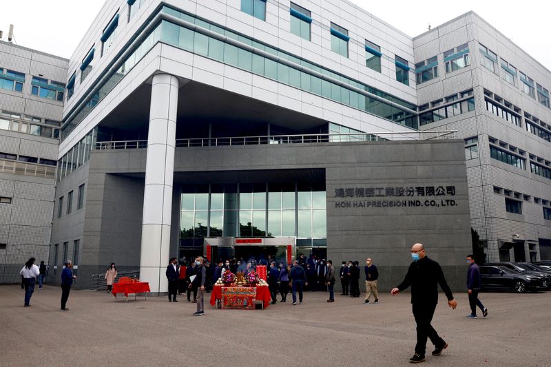 &copy; Reuters. FILE PHOTO: A man walks past Foxconn building after a new year prayer in New Taipei City, Taiwan, February 1, 2023. REUTERS/Ann Wang/File Photo