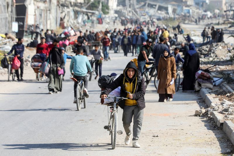 &copy; Reuters. FILE PHOTO: Displaced Palestinians make their way after fleeing the northern part of Gaza amid an Israeli military operation, in Gaza City, November 12, 2024. REUTERS/Dawoud Abu Alkas/ File Photo