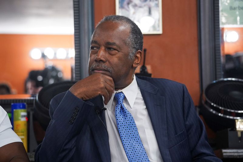 &copy; Reuters. FILE PHOTO: Dr. Ben Carson sits in as Republican presidential candidate and former U.S. President Donald Trump calls in to a campaign event he is hosting for a “Black American Business Leaders Barbershop Roundtable” at Rocky’s Barbershop in Atlanta,