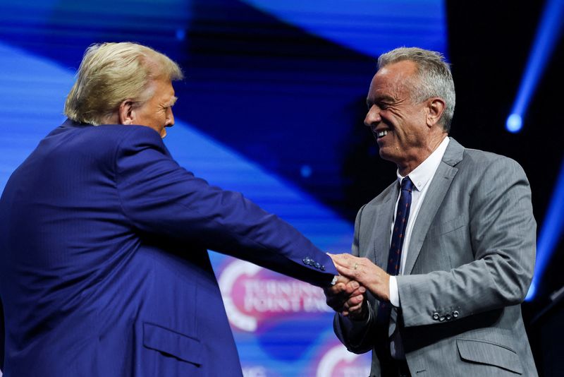 &copy; Reuters. FILE PHOTO: Robert F. Kennedy Jr. and Republican presidential nominee and former U.S. President Donald Trump greet each other at a campaign event sponsored by conservative group Turning Point USA, in Duluth, Georgia, U.S., October 23, 2024. REUTERS/Carlos