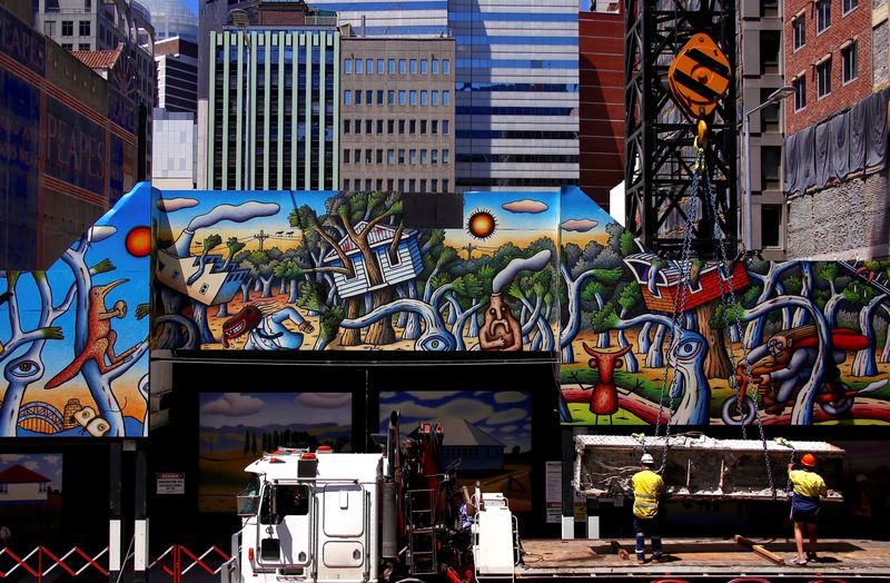 © Reuters. FILE PHOTO: Workers guide a large metal girder as it is lowered by a crane on a construction site for a new building decorated with artwork in Sydney's central business district (CBD), Australia, November 9, 2017.  REUTERS/David Gray