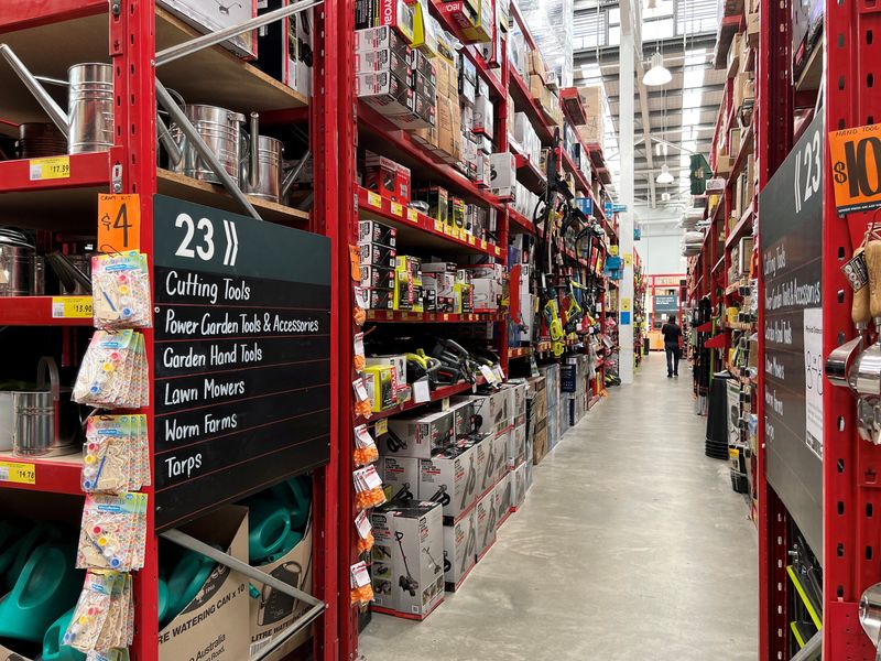 © Reuters. FILE PHOTO: An employee of Bunnings, which is part of the Wesfarmers retail conglomerate, walks down an aisle at a store in Sydney, Australia February 17, 2022. REUTERS/Stephen Coates/File Photo