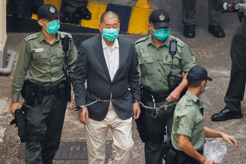 &copy; Reuters. FILE PHOTO:Media mogul Jimmy Lai Chee-ying, founder of Apple Daily, walks to a prison van to head to court, after being charged under the national security law, in Hong Kong, China December 12, 2020. REUTERS/Tyrone Siu/File Photo