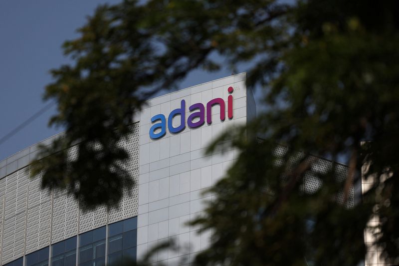 © Reuters. The logo of the Adani Group is seen on the facade of its Corporate House on the outskirts of Ahmedabad, India, November 21, 2024. REUTERS/Amit Dave