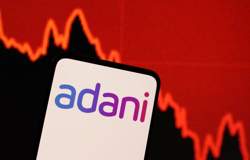 © Reuters. FILE PHOTO: Adani logo and decreasing stock graph is seen in this illustration taken January 31, 2023. REUTERS/Dado Ruvic/Illustration/File Photo