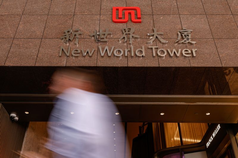 &copy; Reuters. FILE PHOTO: A man walks past the headquarters of New World Development at New World Tower, in Hong Kong, China September 27, 2024. REUTERS/Tyrone Siu/File Photo