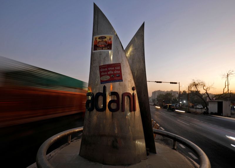 &copy; Reuters. FILE PHOTO: Traffic moves past the logo of the Adani Group installed at a roundabout on the ring road in Ahmedabad, India, February 2, 2023. REUTERS/Amit Dave/File Photo