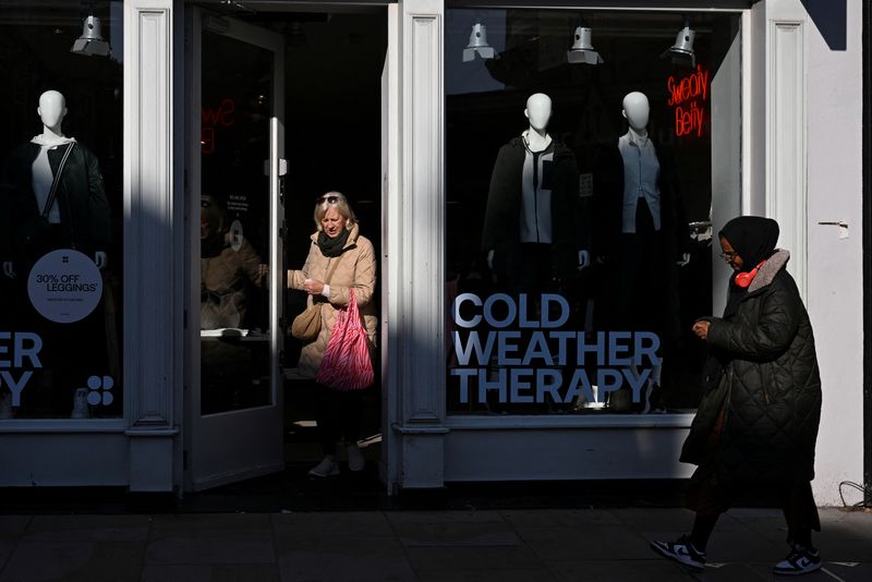 &copy; Reuters. A woman walks out of a store advertising for cold weather clothing in Richmond, London, Britain, October 11, 2024. REUTERS/Jaimi Joy/File Photo