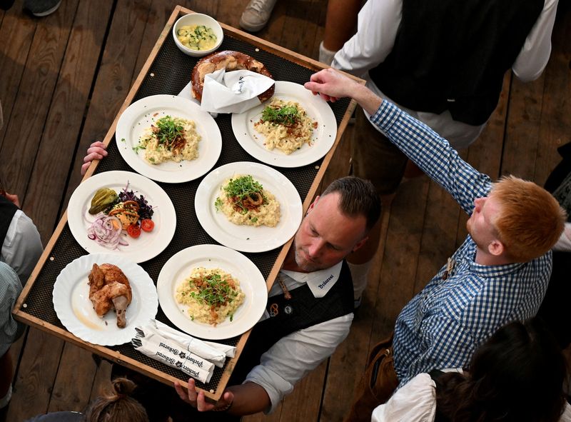 &copy; Reuters. FILE PHOTO: A waiter carries food on the day of the official opening of the 189th Oktoberfest, the world's largest beer festival in Munich, Germany, September 21, 2024. REUTERS/Angelika Warmuth/File Photo