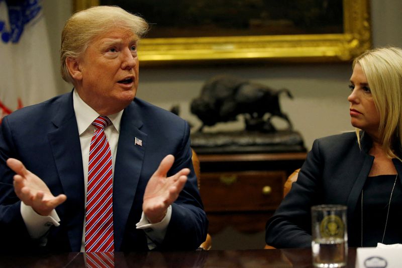 &copy; Reuters. FILE PHOTO: U.S. President Donald Trump makes a point about gun safety in schools while Attorney General Pam Bondi (R-FL) listens during a meeting with local and state officials about improving school safety at the White House in Washington, U.S., Februar