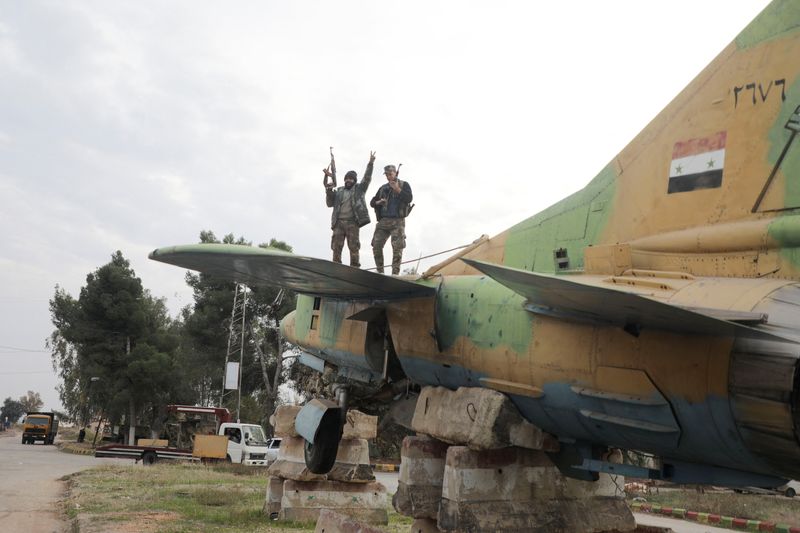 © Reuters. Rebel fighters at Hama's military airport, Syria December 7, 2024. REUTERS/Mahmoud Hasano