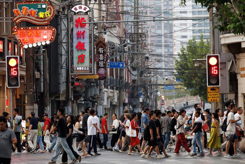 © Reuters. FILE PHOTO: People walk past a lane lined up with restaurants, at a shopping area in Shanghai, China September 28, 2024. REUTERS/Tingshu Wang/File Photo