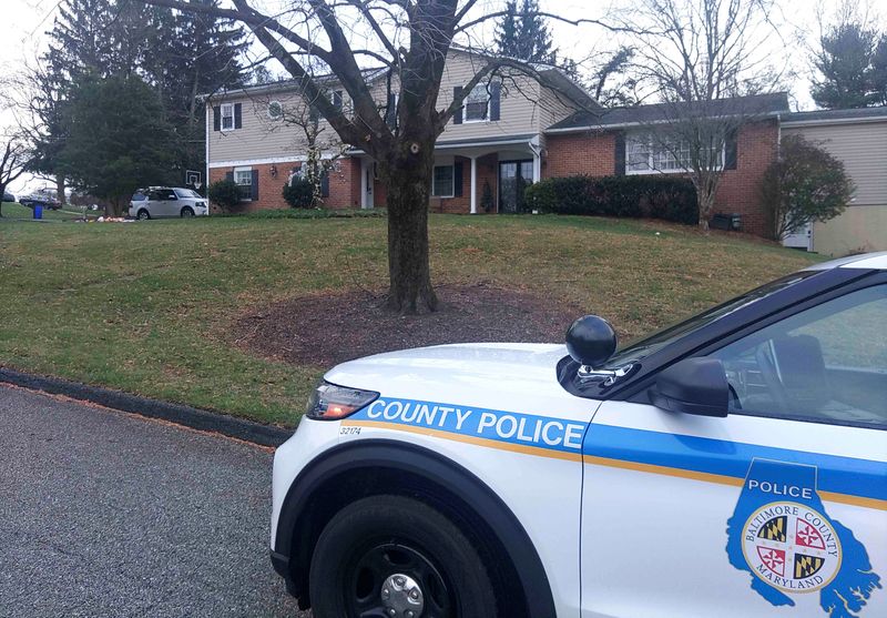 &copy; Reuters. A Baltimore County Police squad car sits outside a former home of the Mangione family after it was reported that police in Altoona, Pennsylvania had arrested shooting suspect Luigi Mangione, 26, identified in the killing of UnitedHealth executive Brian Th