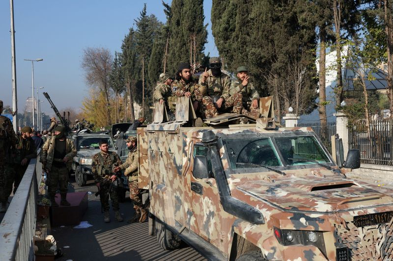 &copy; Reuters. Rebel fighters sit on a vehicle, after rebels seized the capital and ousted President Bashar al-Assad, in Damascus, Syria, December 9, 2024. REUTERS/Mohamed Azakir/File Photo