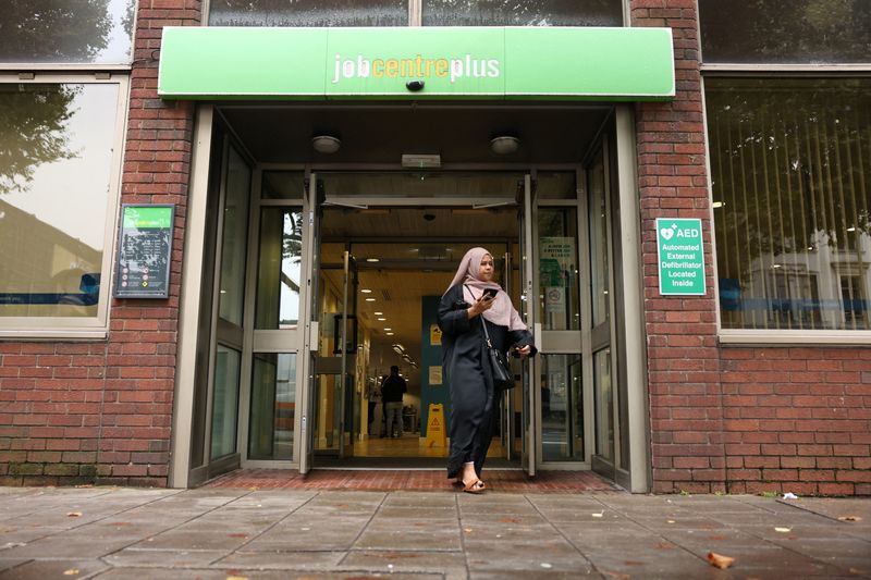 &copy; Reuters. FILE PHOTO: A person walks out of a job centre, in London, Britain, September 6, 2024. REUTERS/Mina Kim/File Photo